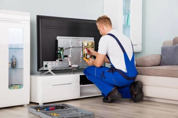 Technician repairing modern television
